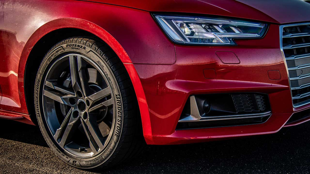 A View Of The Sidewall Of The Bridgestone Potenza Sport On A Red Passenger Car